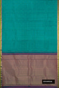 Green Dual Tone Kanchipuram Silk Saree with Zari Butta on the body and Zari Border.  displayed on a mannequin