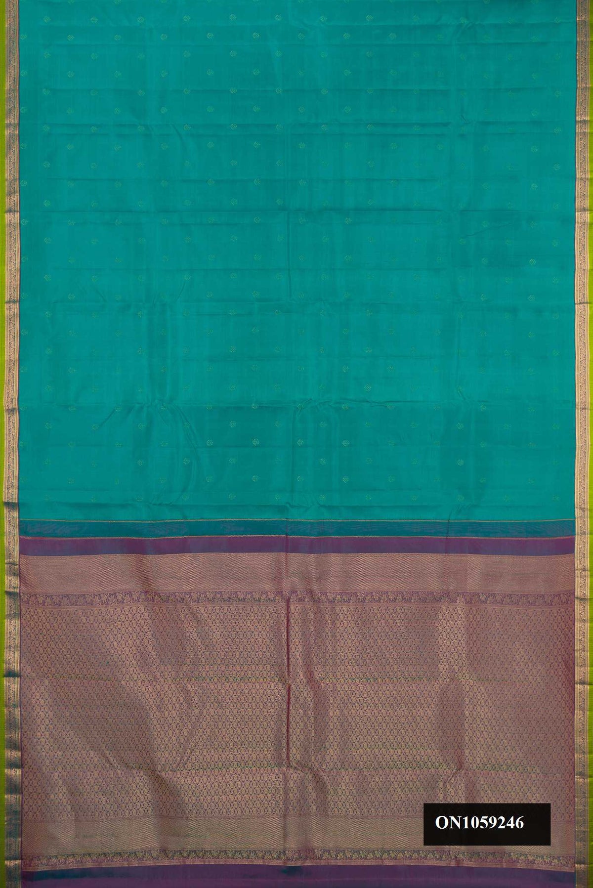 Green Dual Tone Kanchipuram Silk Saree with Zari Butta on the body and Zari Border.  displayed on a mannequin