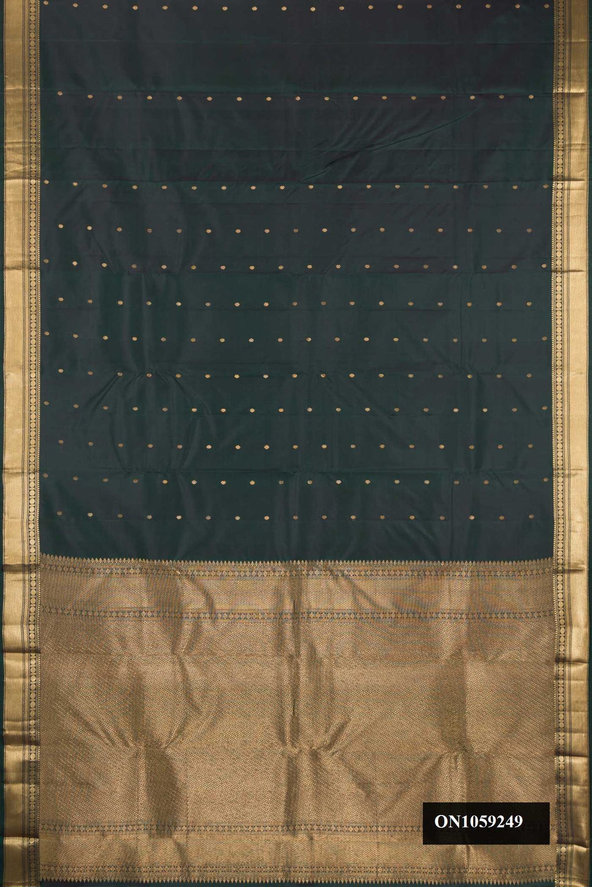 Bottle Green Dual Tone Kanchipuram Silk Saree with Zari Butta on the body and Zari Border.  displayed on a mannequin