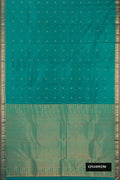 Green Dual Tone Kanchipuram Silk Saree with Zari Butta on the body and Zari Border.  displayed on a mannequin