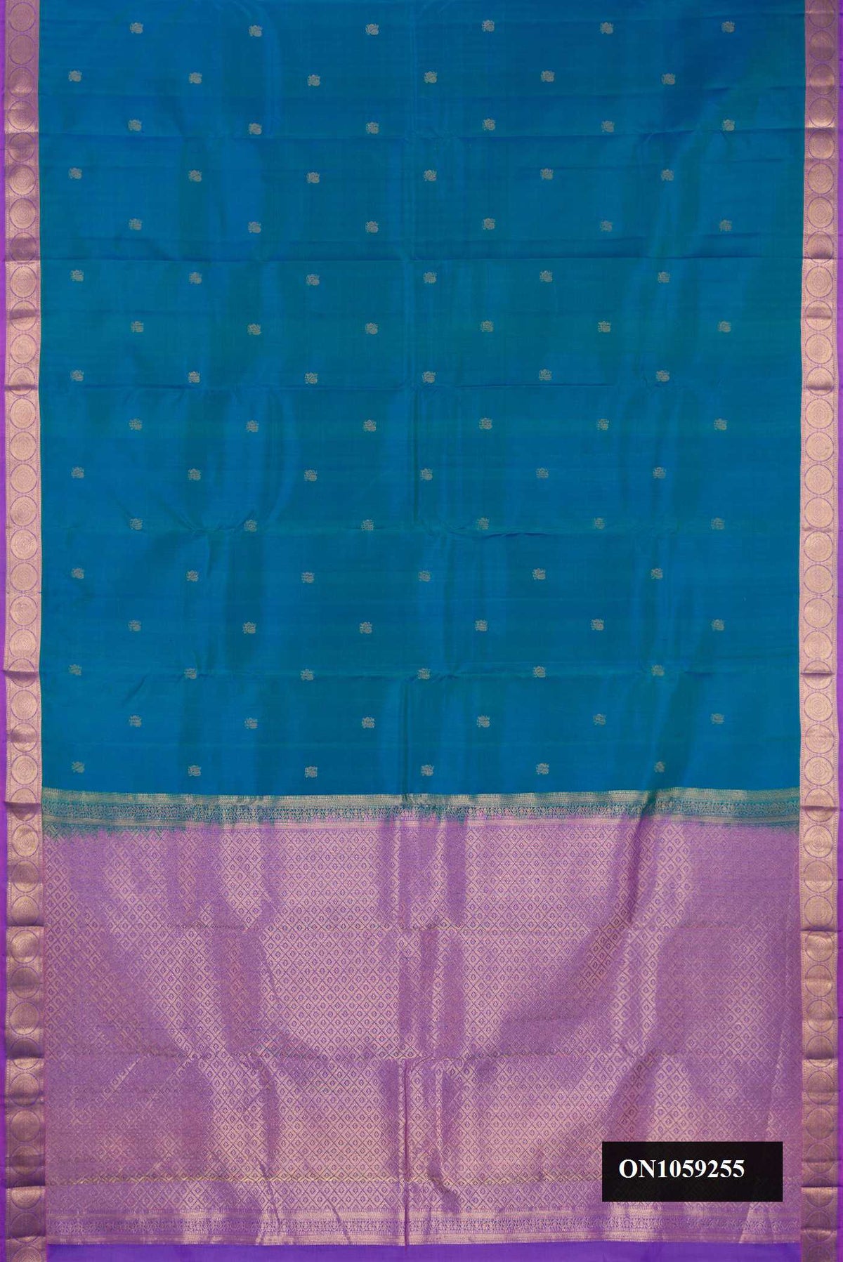 Peacock Blue Dual Tone Kanchipuram Silk Saree with Zari Butta on the body and Zari Border.  displayed on a mannequin