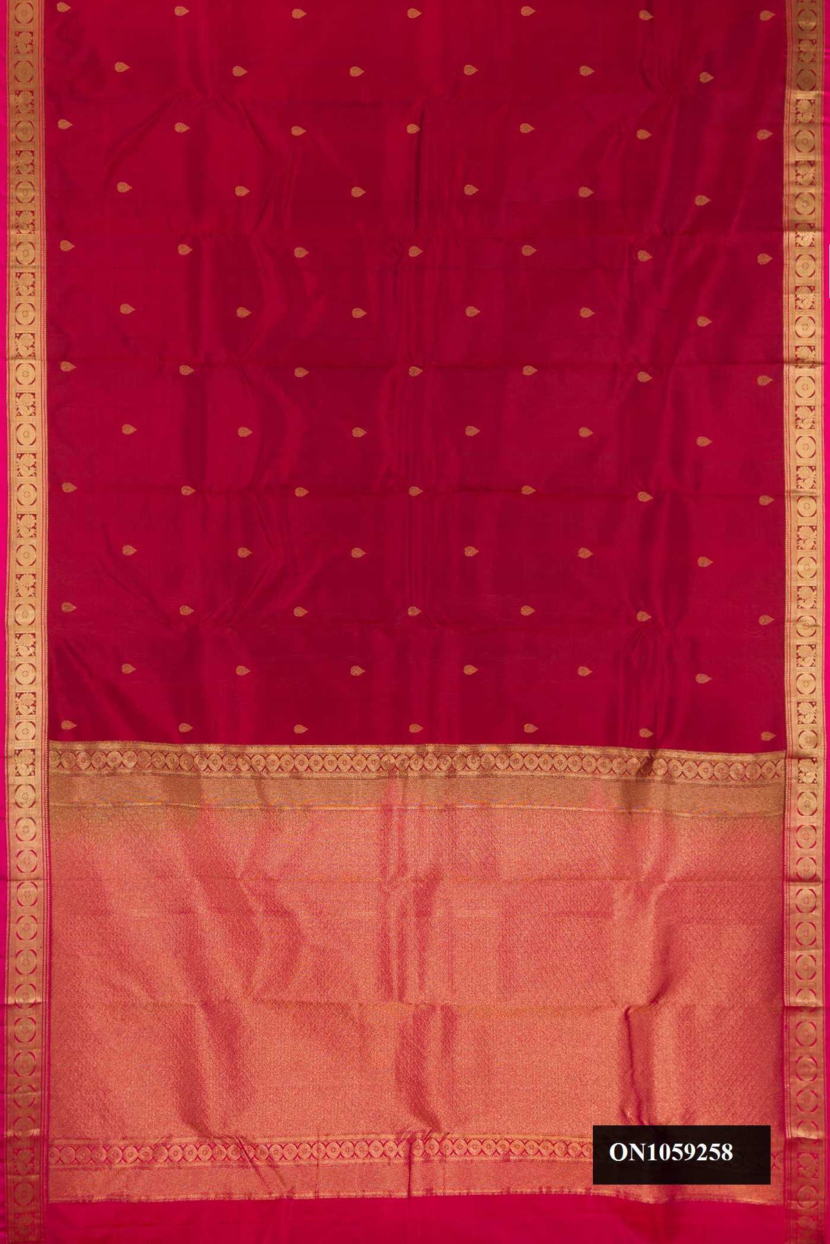 Maroon Dual Tone Kanchipuram Silk Saree with Zari Butta on the body and Zari Border.  displayed on a mannequin