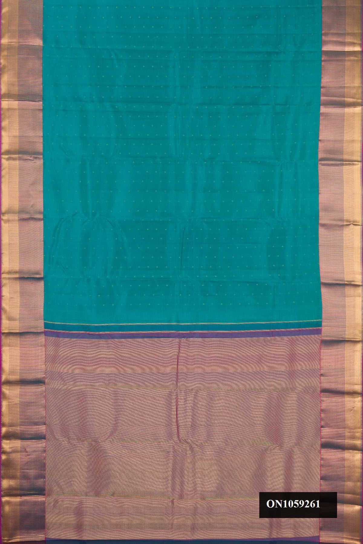 Green Dual Tone Kanchipuram Silk Saree with Zari Butta on the body and Zari Border.  displayed on a mannequin