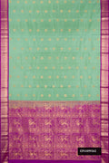 Pista Green Dual Tone Kanchipuram Silk Saree with Zari Butta on the body and Zari Border.  displayed on a mannequin