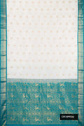 White Dual Tone Kanchipuram Silk Saree with Zari Butta on the body and Zari Border.  displayed on a mannequin