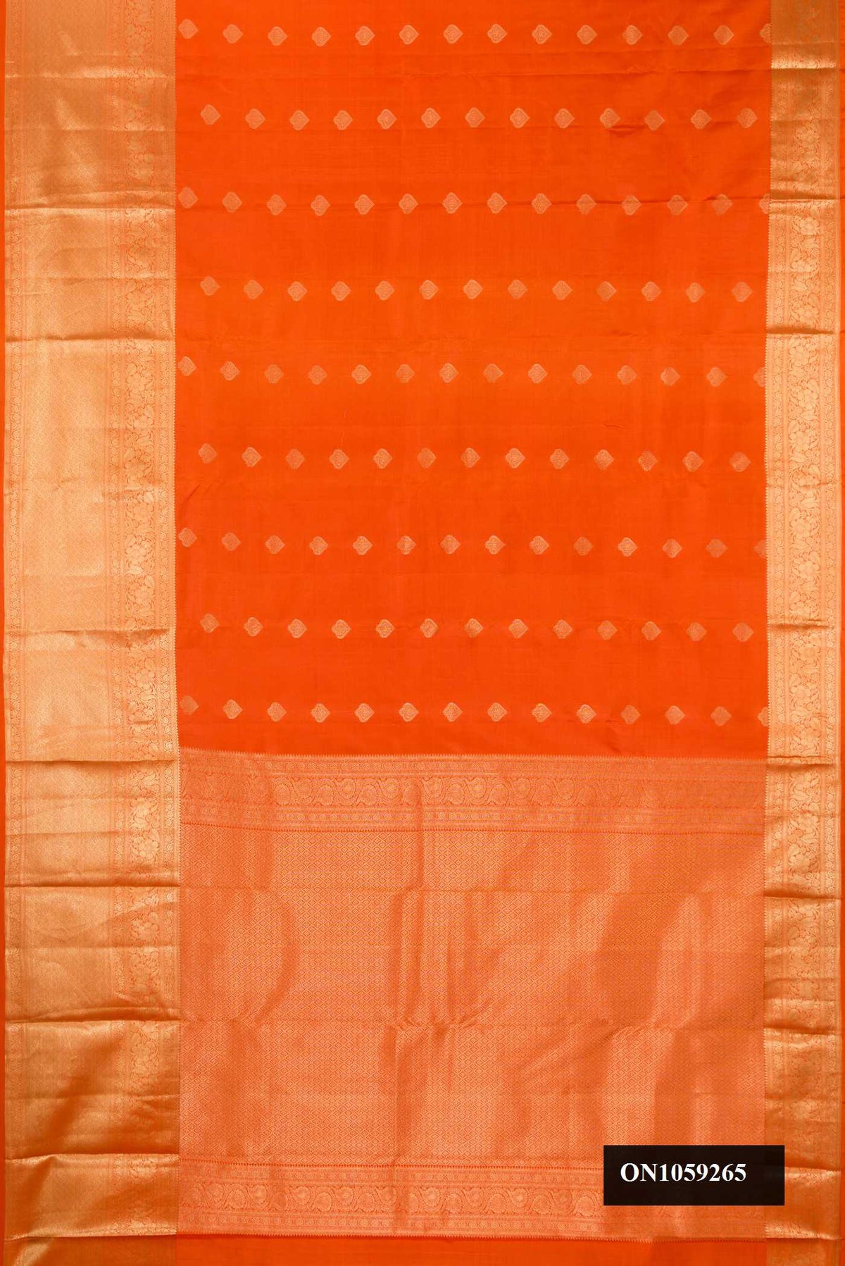 Orange Dual Tone Kanchipuram Silk Saree with Zari Butta on the body and Zari Border.  displayed on a mannequin