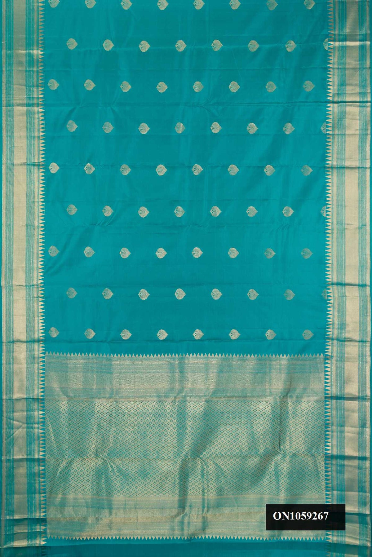Peacock Blue Dual Tone Kanchipuram Silk Saree with Zari Butta on the body and Fancy Border.  displayed on a mannequin