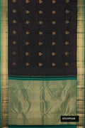 Black Dual Tone Kanchipuram Silk Saree with Zari Butta on the body and Zari Border.  displayed on a mannequin