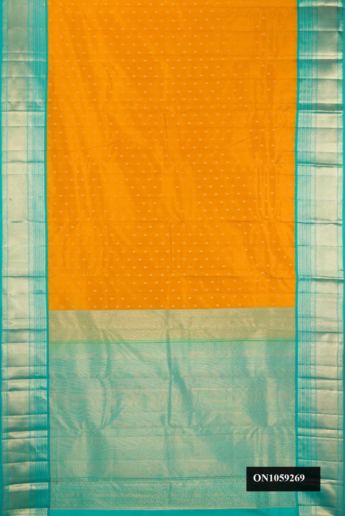 Mustard Dual Tone Kanchipuram Silk Saree with Zari Butta on the body and Zari Border.  displayed on a mannequin