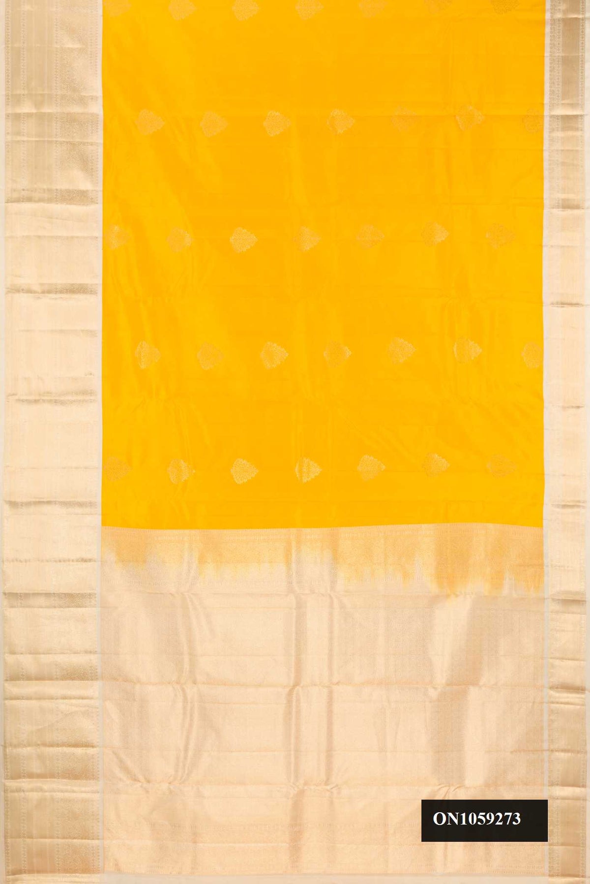Yellow Dual Tone Kanchipuram Silk Saree with Zari Butta on the body and Zari Border.  displayed on a mannequin