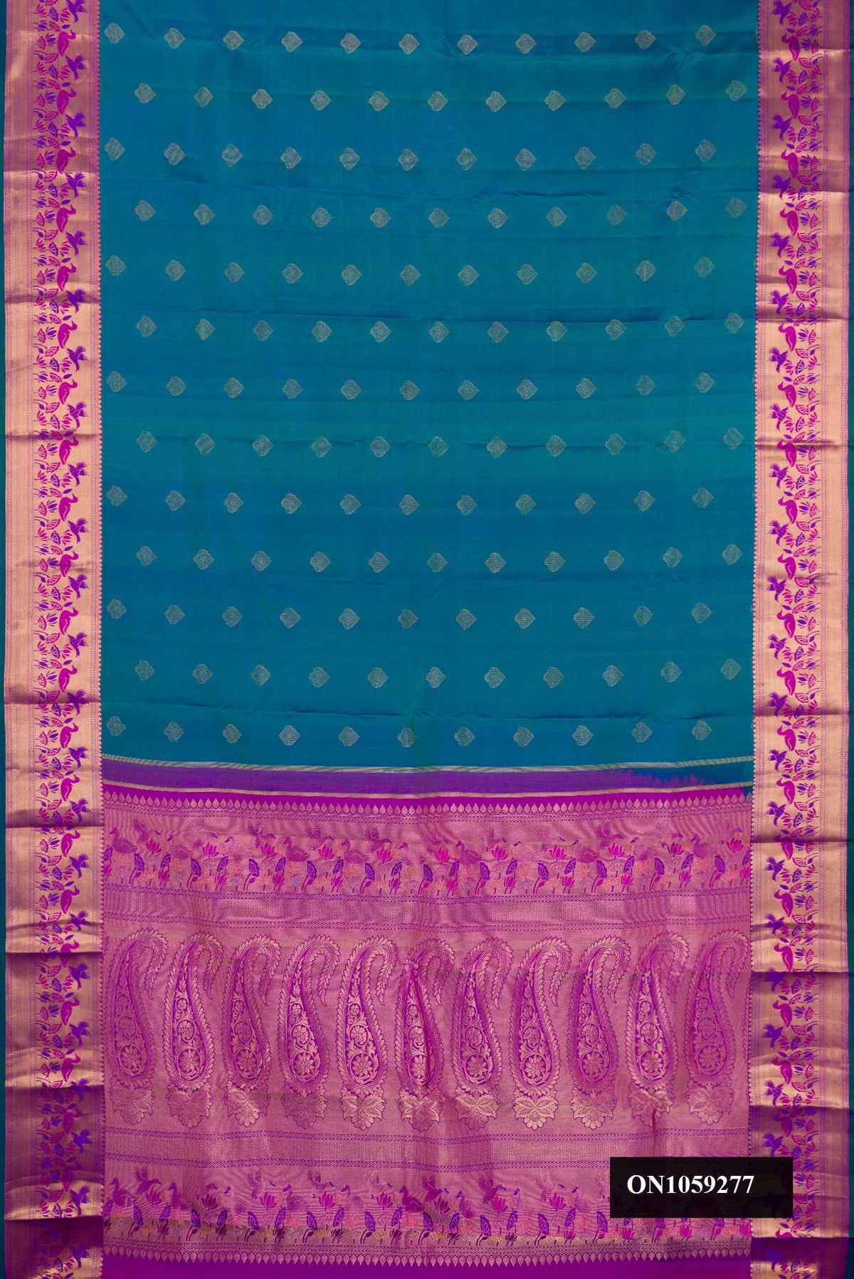 Peacock Blue Dual Tone Kanchipuram Silk Saree with Zari Butta on the body and Fancy Border.  displayed on a mannequin