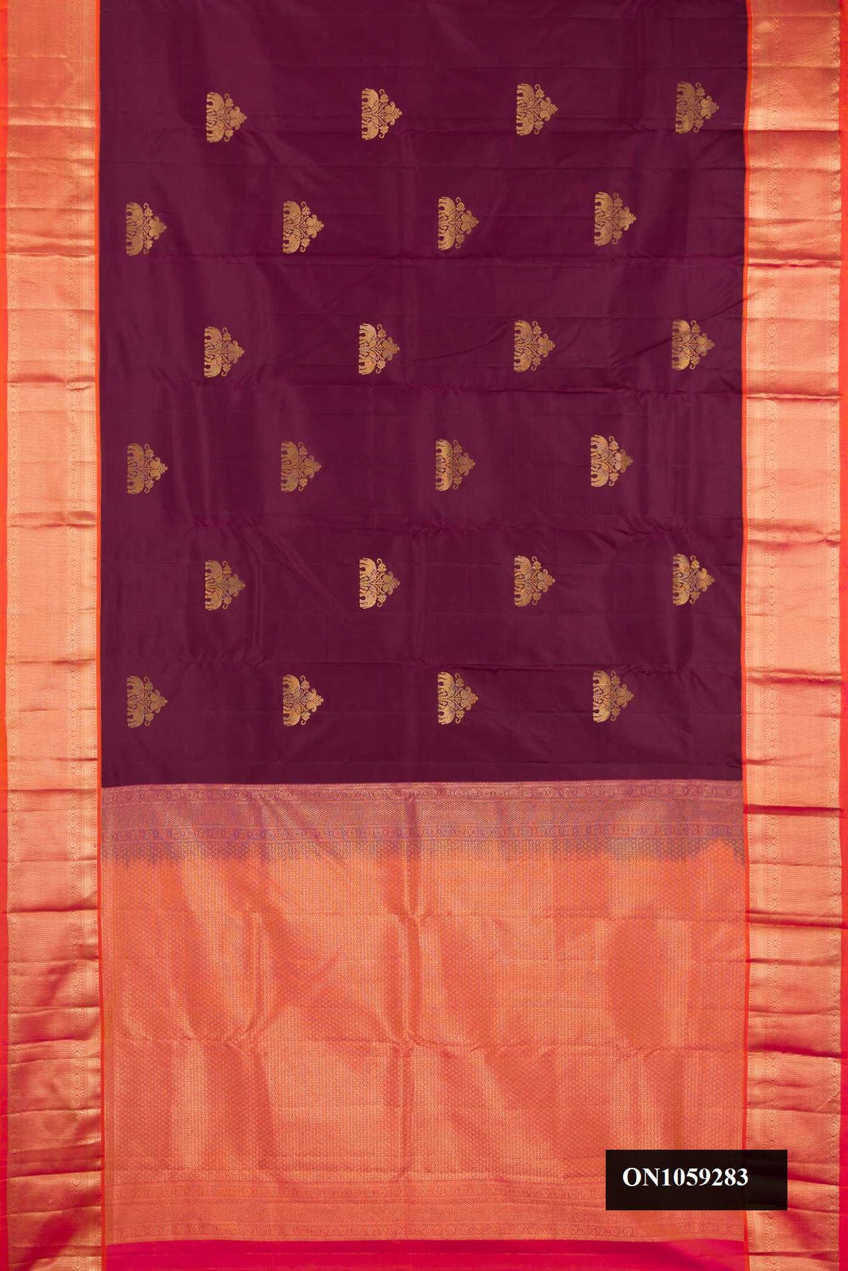 Brown Dual Tone Kanchipuram Silk Saree with Zari Butta on the body and Zari Border.  displayed on a mannequin