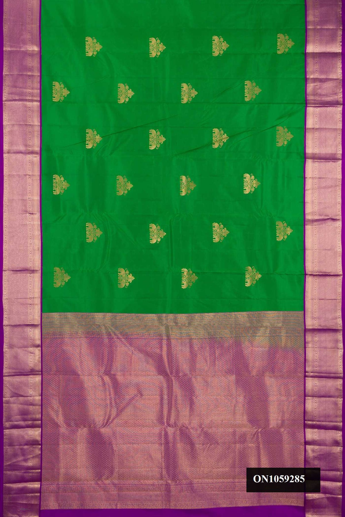 Green Dual Tone Kanchipuram Silk Saree with Zari Butta on the body and Zari Border.  displayed on a mannequin