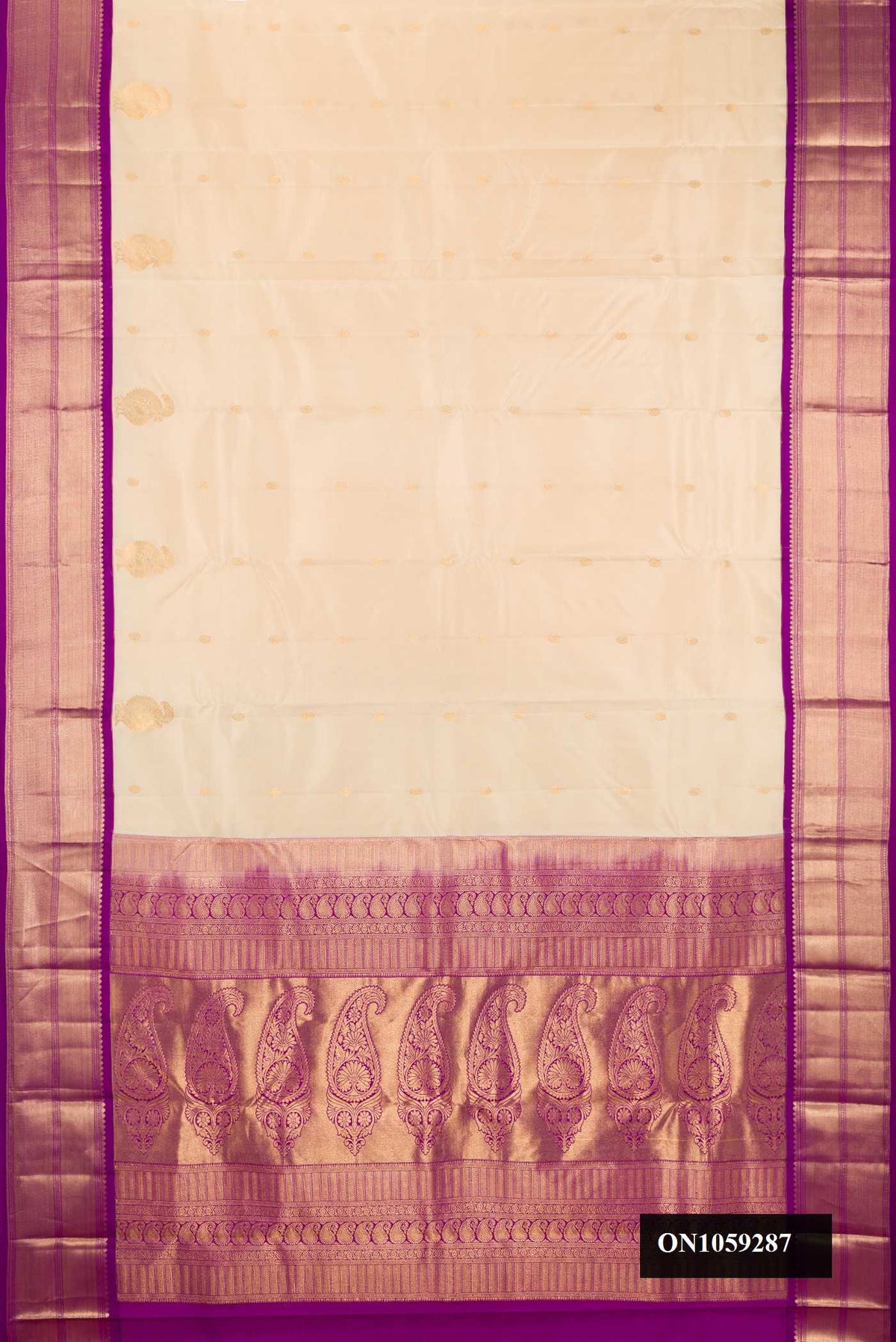 Beige Dual Tone Kanchipuram Silk Saree with Zari Butta on the body and Zari Border.  displayed on a mannequin