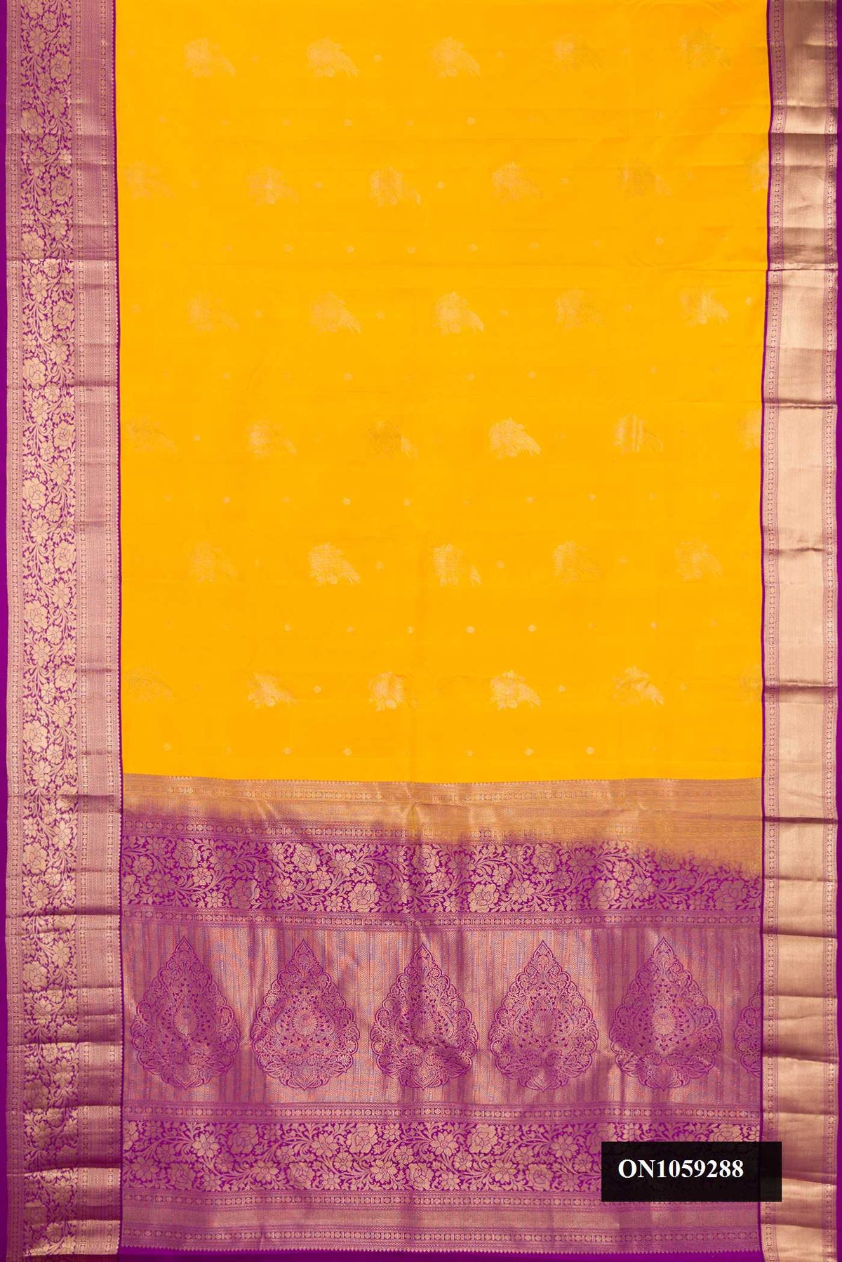 Yellow Dual Tone Kanchipuram Silk Saree with Zari Butta on the body and Zari Border.  displayed on a mannequin