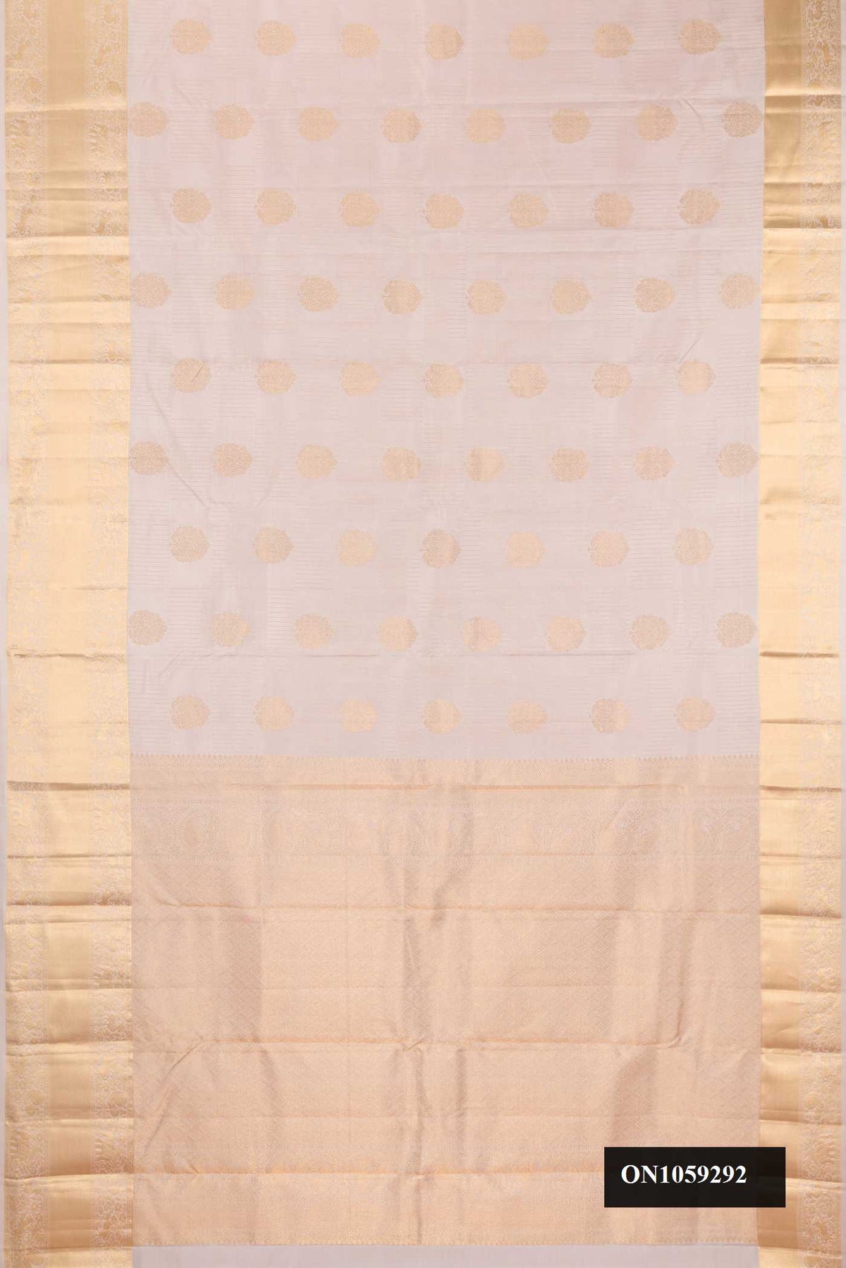 Rose Gold Dual Tone Kanchipuram Silk Saree with Stripes on the body and Zari Border.  displayed on a mannequin