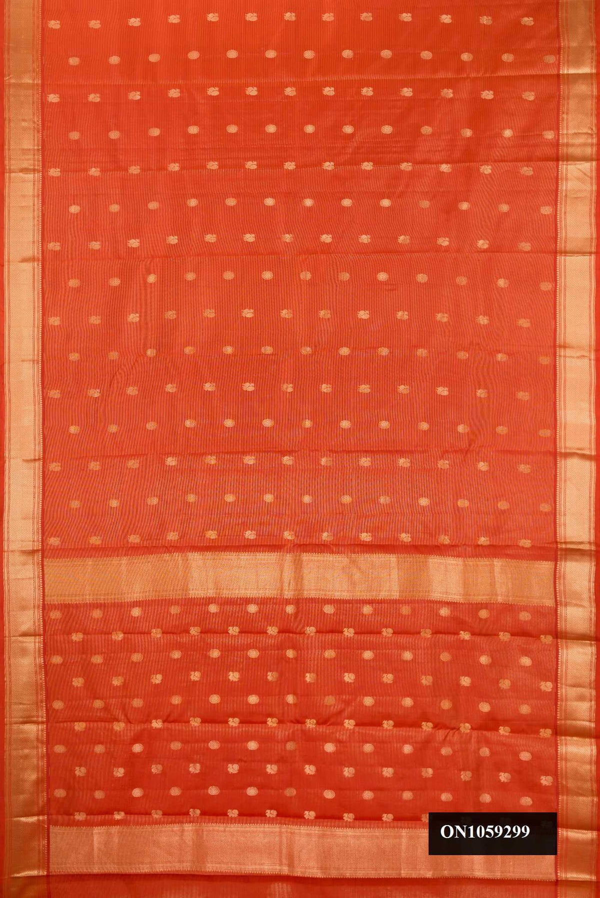 Rust Dual Tone Kanchipuram Silk Saree with Stripes on the body and Zari Border.  displayed on a mannequin