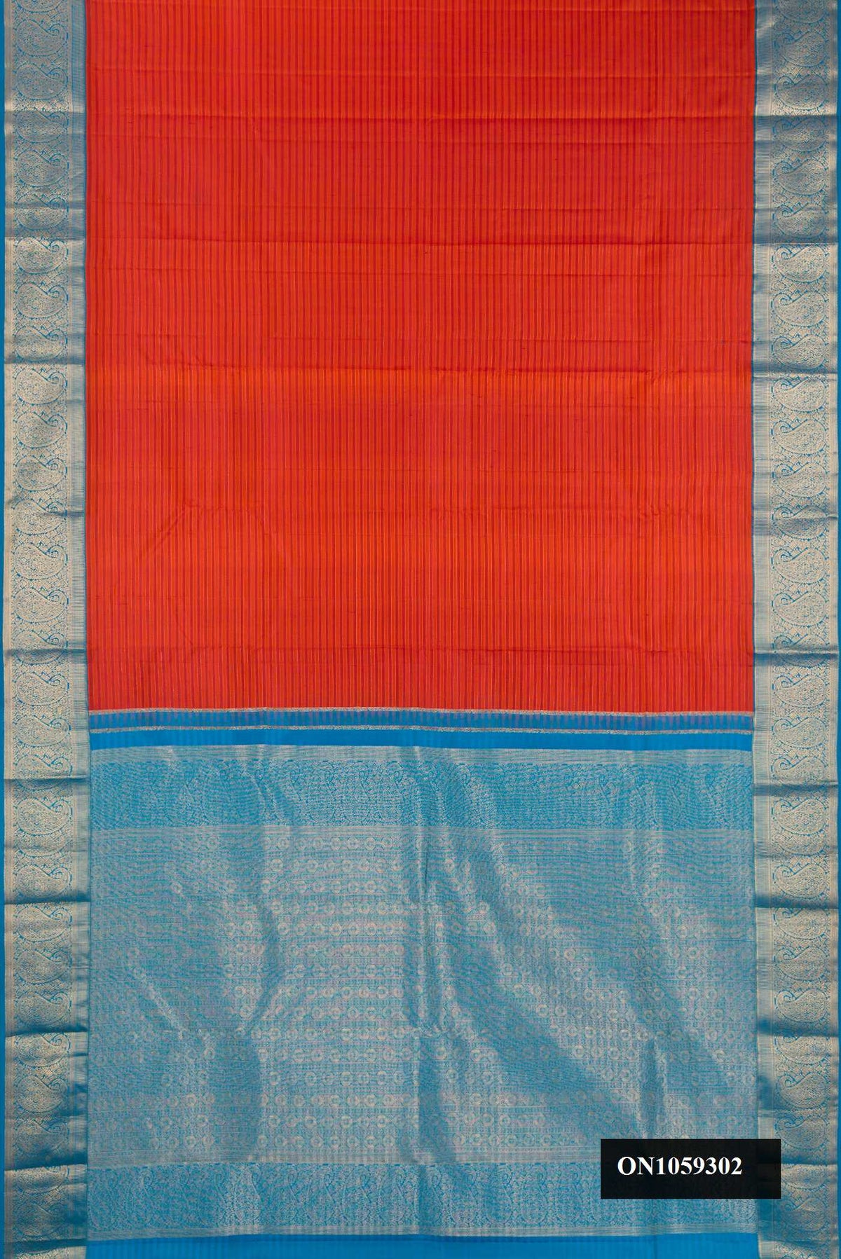 Brick Orange Dual Tone Kanchipuram Silk Saree with Stripes on the body and Zari Border.  displayed on a mannequin