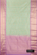 Pista Green Dual Tone Kanchipuram Silk Saree with Zari Butta on the body and Zari Border.  displayed on a mannequin