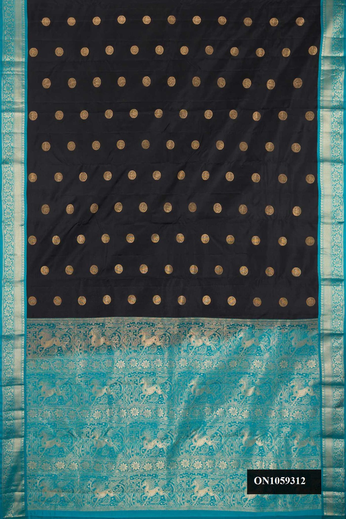 Black Dual Tone Kanchipuram Silk Saree with Zari Butta on the body and Zari Border.  displayed on a mannequin