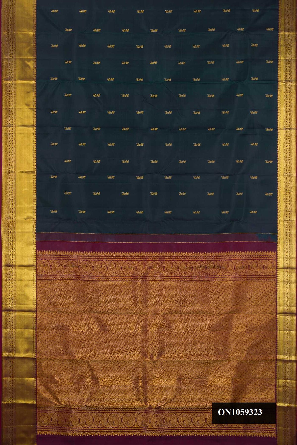 Bottle Green Dual Tone Kanchipuram Silk Saree with Zari Butta on the body and Zari Border.  displayed on a mannequin
