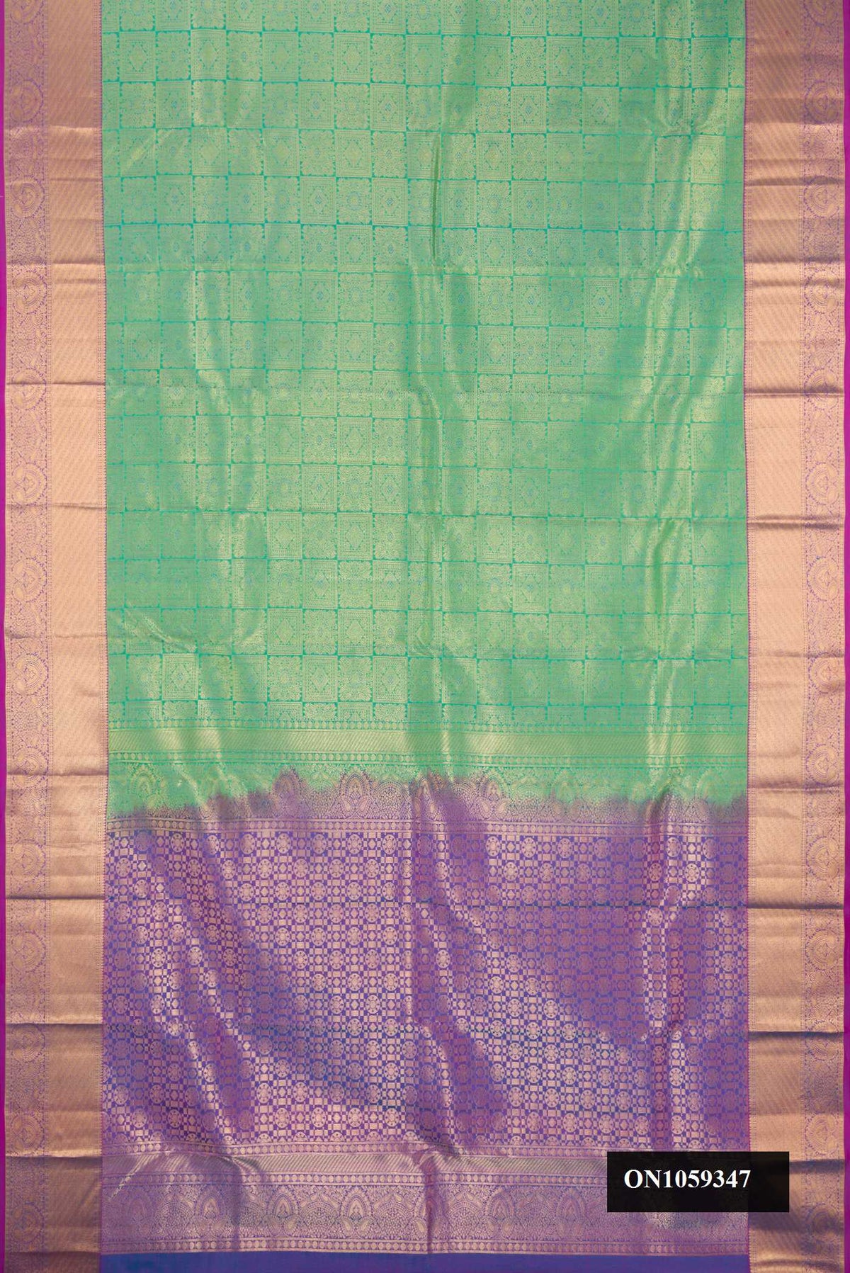 Green Dual Tone Kanchipuram Silk Saree with Zari Brocade on the body and Zari Border.  displayed on a mannequin