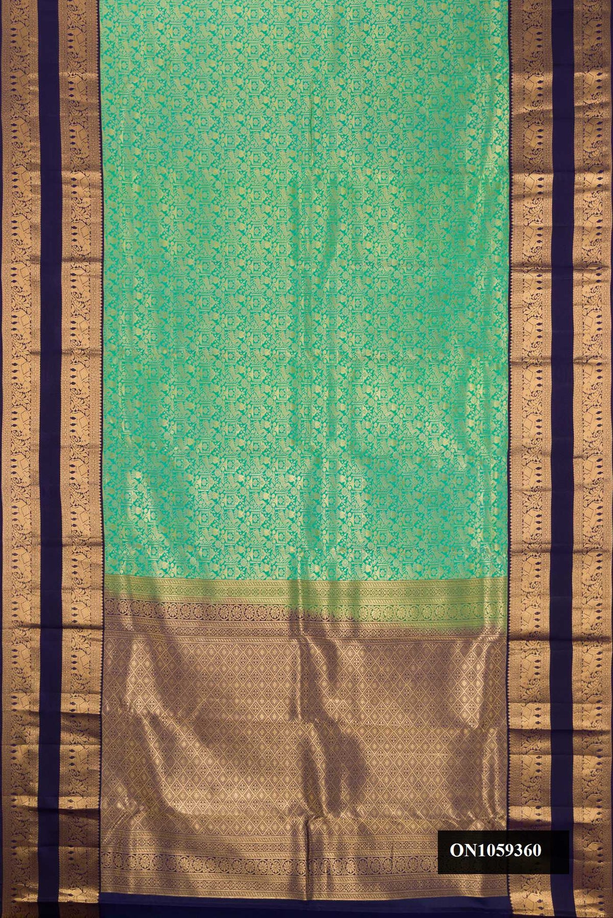 Sea Green Dual Tone Kanchipuram Silk Saree with Zari Brocade on the body and Zari Border.  displayed on a mannequin