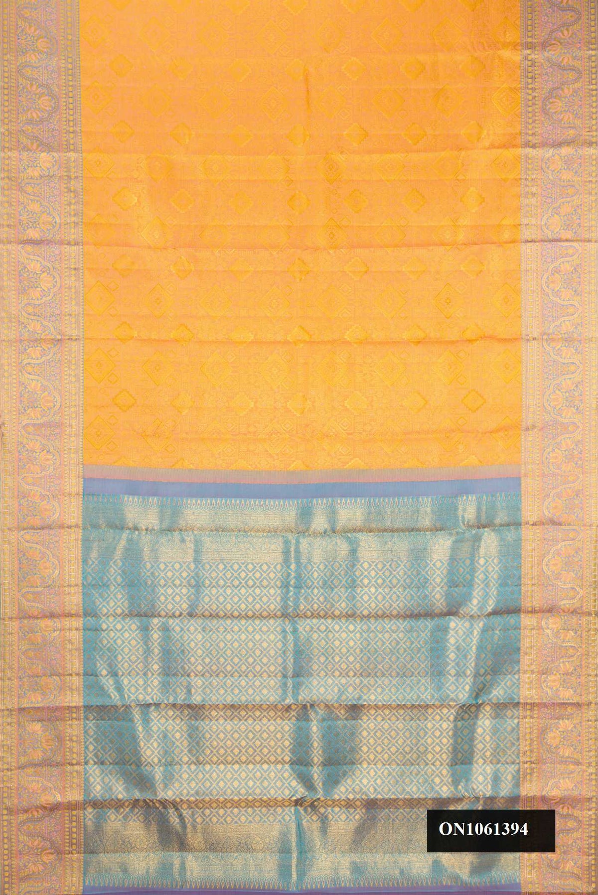Mustard Dual Tone Kanchipuram Silk Saree with Zari Brocade on the body and Fancy Border.  displayed on a mannequin
