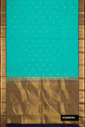Green Dual Tone Kanchipuram Silk Saree with Zari Butta on the body and Zari Border.  displayed on a mannequin