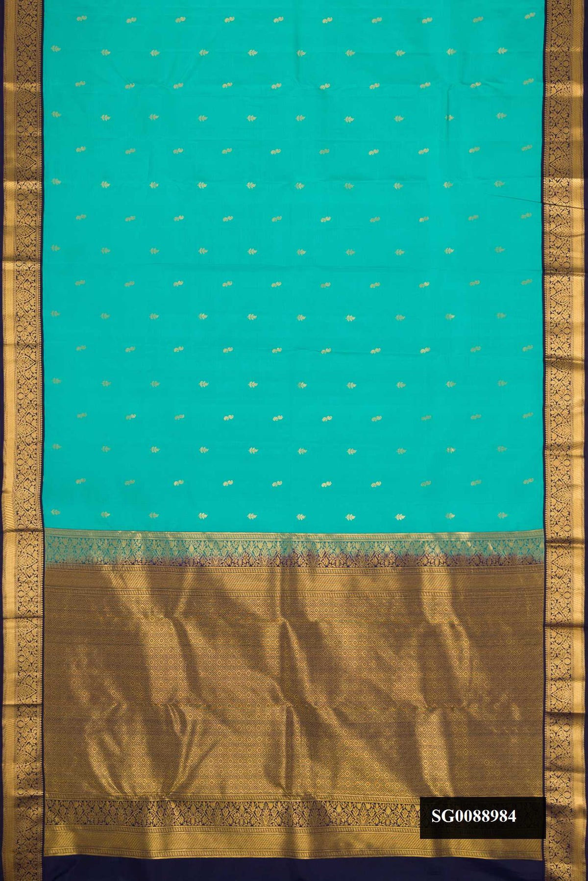 Green Dual Tone Kanchipuram Silk Saree with Zari Butta on the body and Zari Border.  displayed on a mannequin