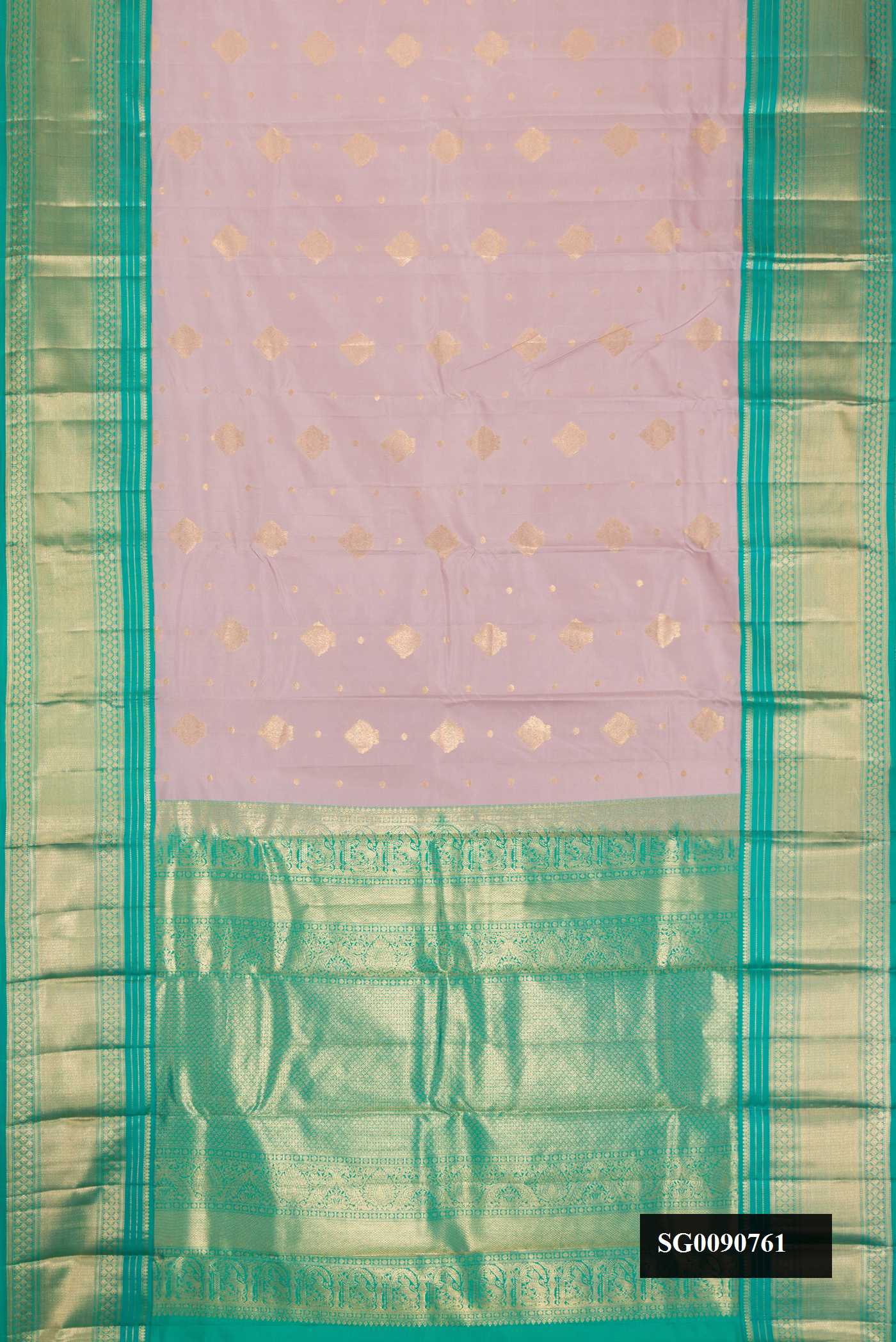 Lilac Kanchipuram Silk Saree with Zari Butta on the body and Zari Border.  displayed on a mannequin