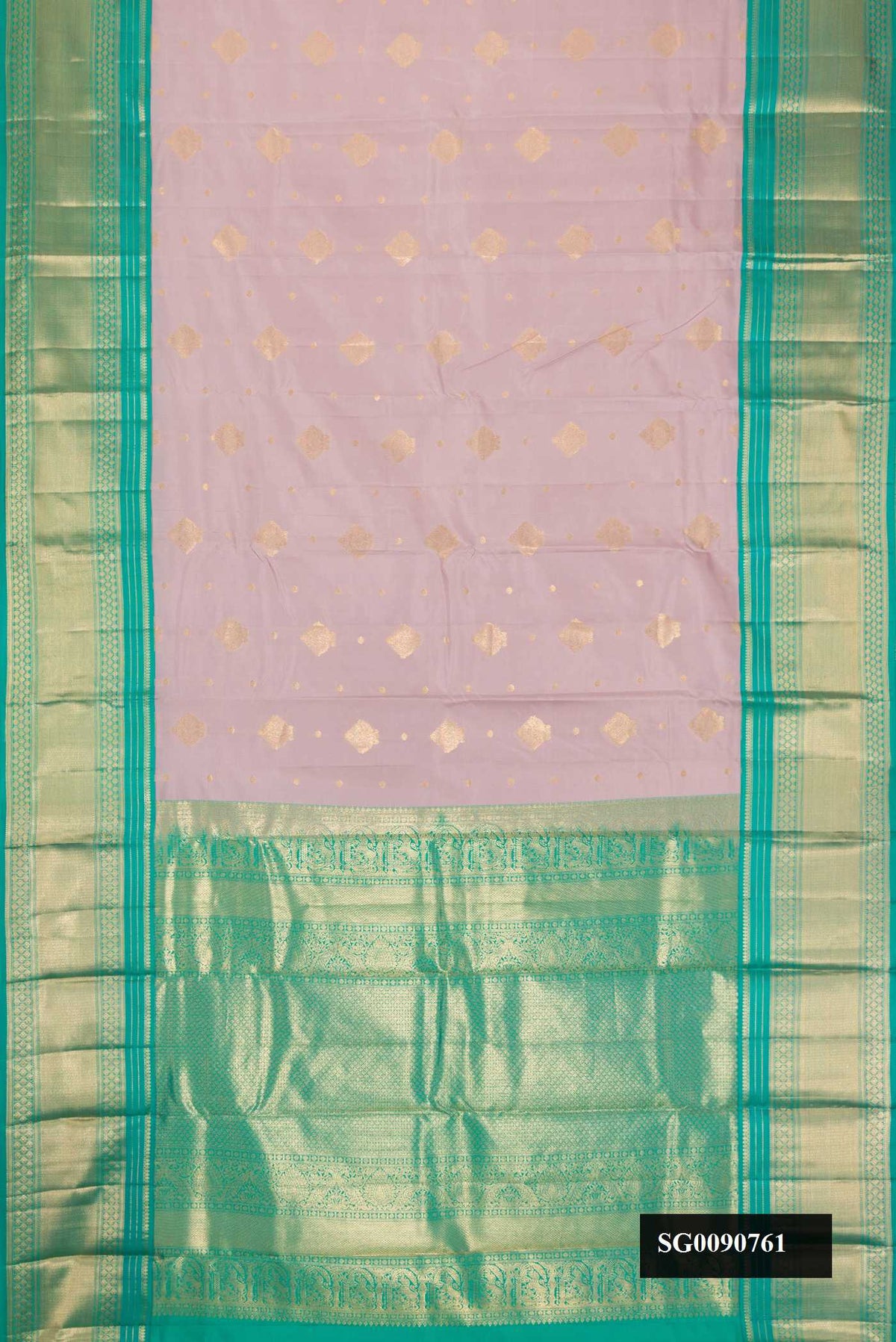 Lilac Kanchipuram Silk Saree with Zari Butta on the body and Zari Border.  displayed on a mannequin