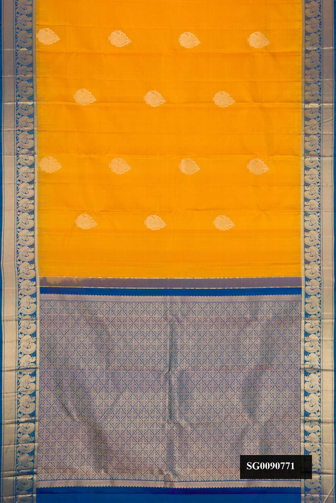 Mustard Kanchipuram Silk Saree with Zari Butta on the body and Zari Border.  displayed on a mannequin