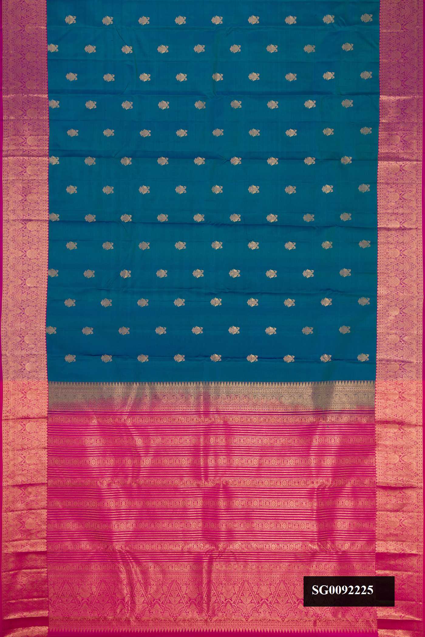 Peacock Blue Dual Tone Kanchipuram Silk Saree with Zari Butta on the body and Zari Border.  displayed on a mannequin