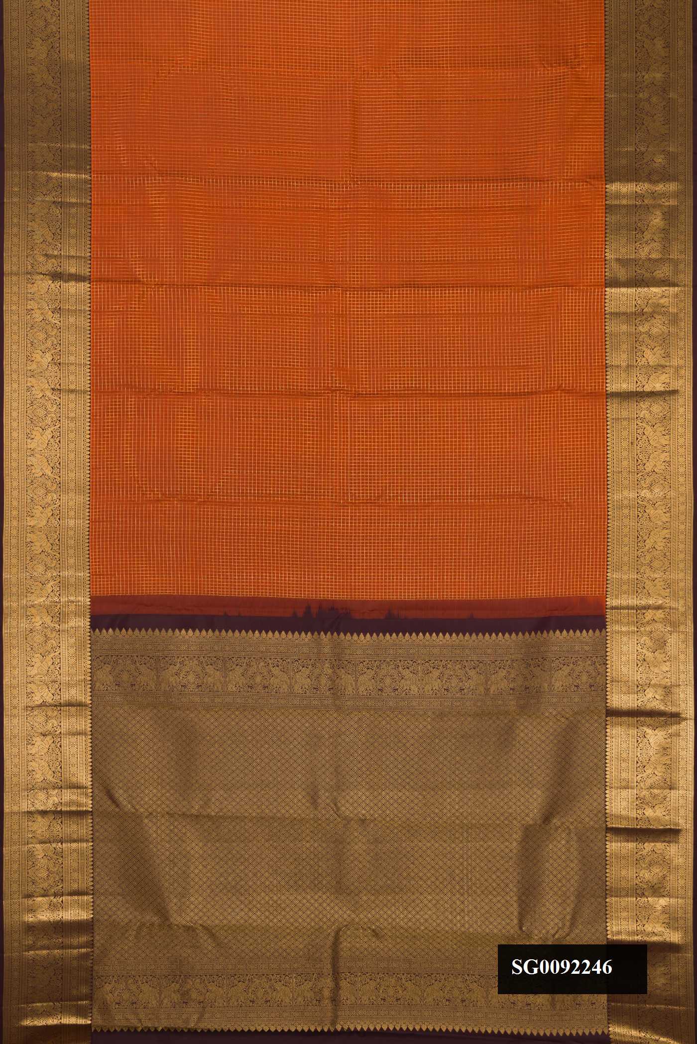 Brick Orange Dual Tone Kanchipuram Silk Saree with Checked design on the body and Zari Border.  displayed on a mannequin
