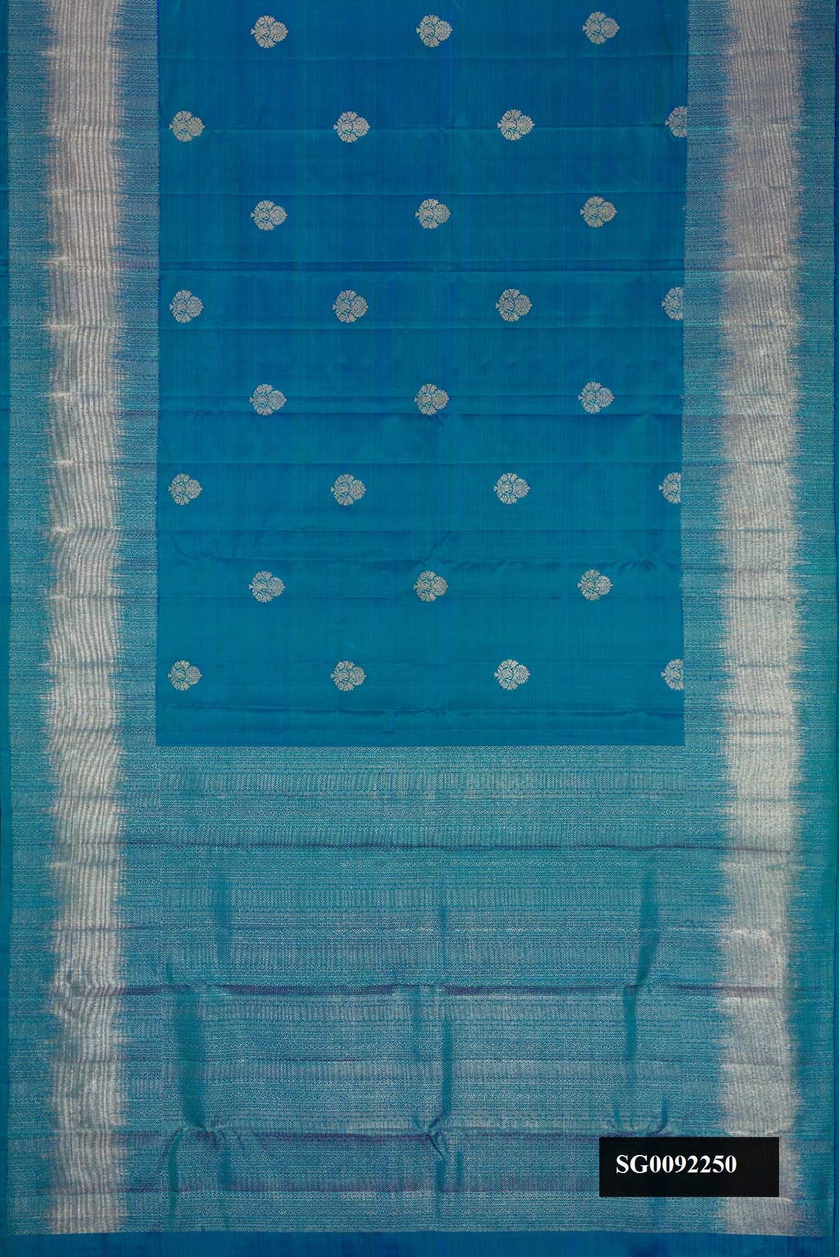 Peacock Blue Dual Tone Kanchipuram Silk Saree with Zari Butta on the body and Zari Border.  displayed on a mannequin