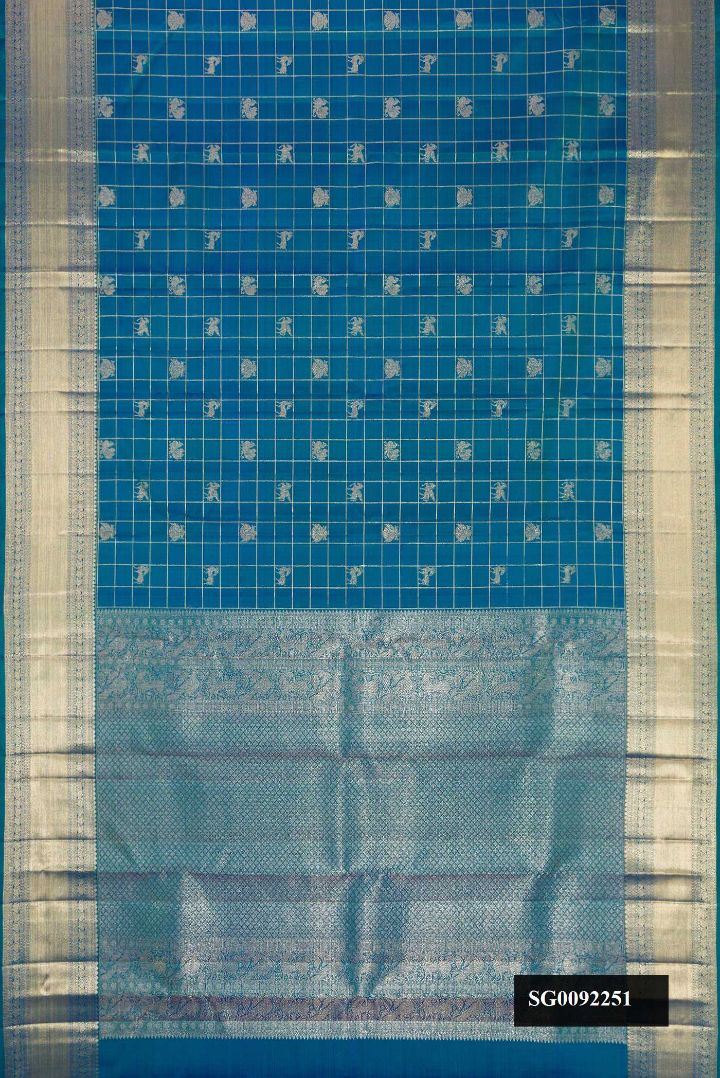 Peacock Blue Dual Tone Kanchipuram Silk Saree with Checked design on the body and Zari Border.  displayed on a mannequin