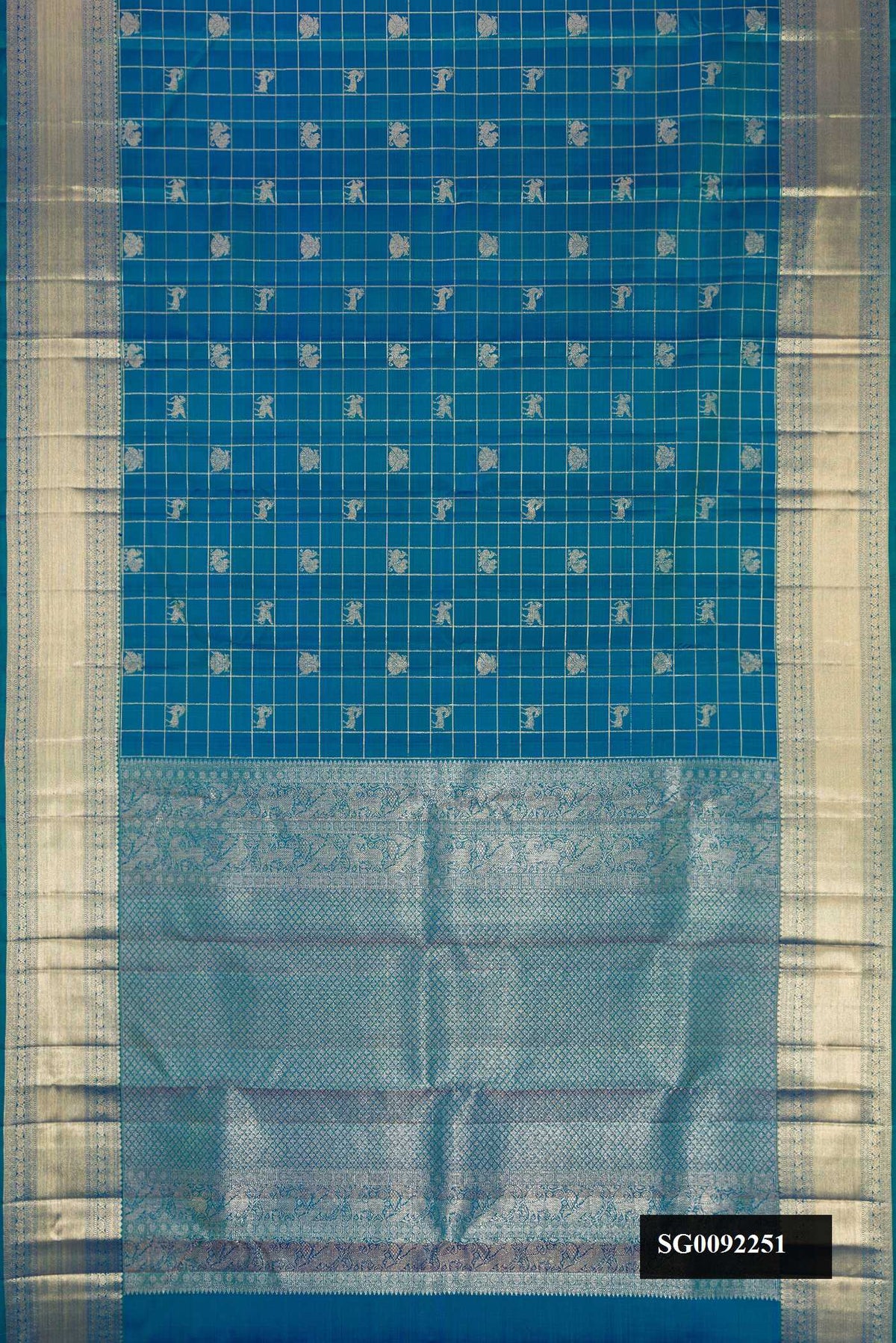 Peacock Blue Dual Tone Kanchipuram Silk Saree with Checked design on the body and Zari Border.  displayed on a mannequin
