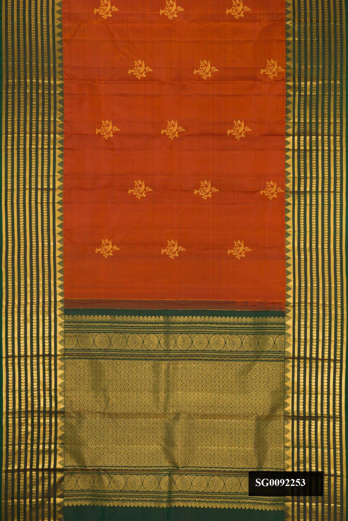 Brick Orange Dual Tone Kanchipuram Silk Saree with Zari Butta on the body and Zari Border.  displayed on a mannequin