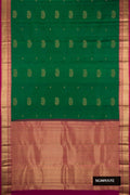 Bottle Green Dual Tone Kanchipuram Silk Saree with Zari Butta on the body and Zari Border.  displayed on a mannequin