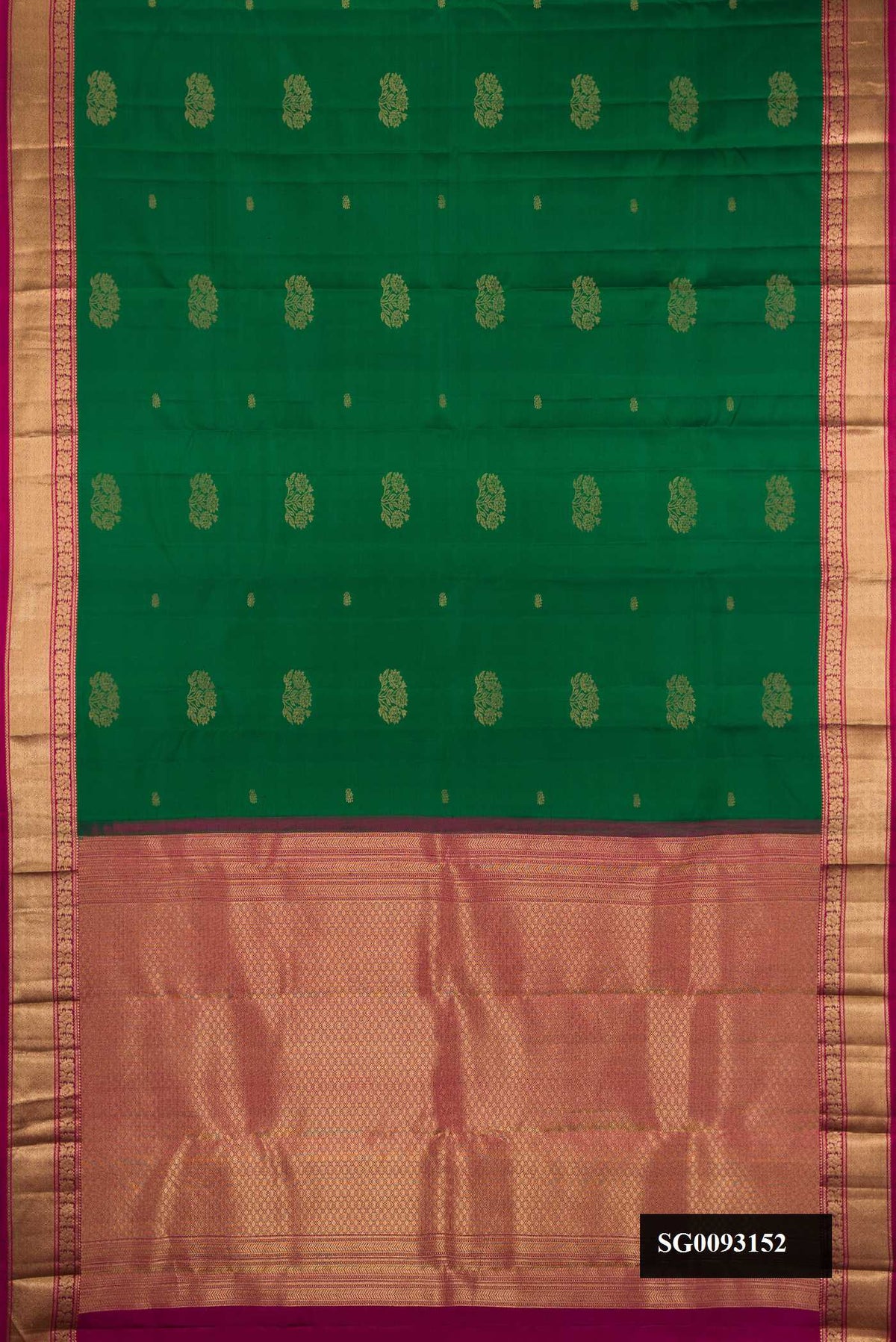 Bottle Green Dual Tone Kanchipuram Silk Saree with Zari Butta on the body and Zari Border.  displayed on a mannequin