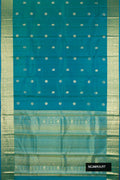 Peacock Blue Dual Tone Kanchipuram Silk Saree with Zari Butta on the body and Zari Border.  displayed on a mannequin