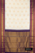 Off White Dual Tone Kanchipuram Silk Saree with Zari Butta on the body and Zari Border.  displayed on a mannequin