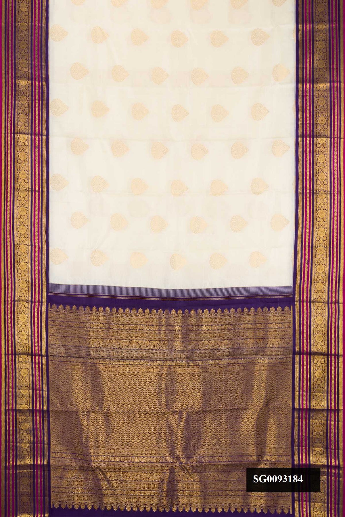 Off White Dual Tone Kanchipuram Silk Saree with Zari Butta on the body and Zari Border.  displayed on a mannequin