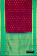 Maroon Dual Tone Kanchipuram Silk Saree with Zari Butta on the body and Zari Border.  displayed on a mannequin