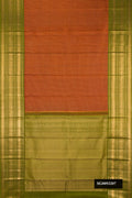 Rust Dual Tone Kanchipuram Silk Saree with Checked design on the body and Zari Border.  displayed on a mannequin