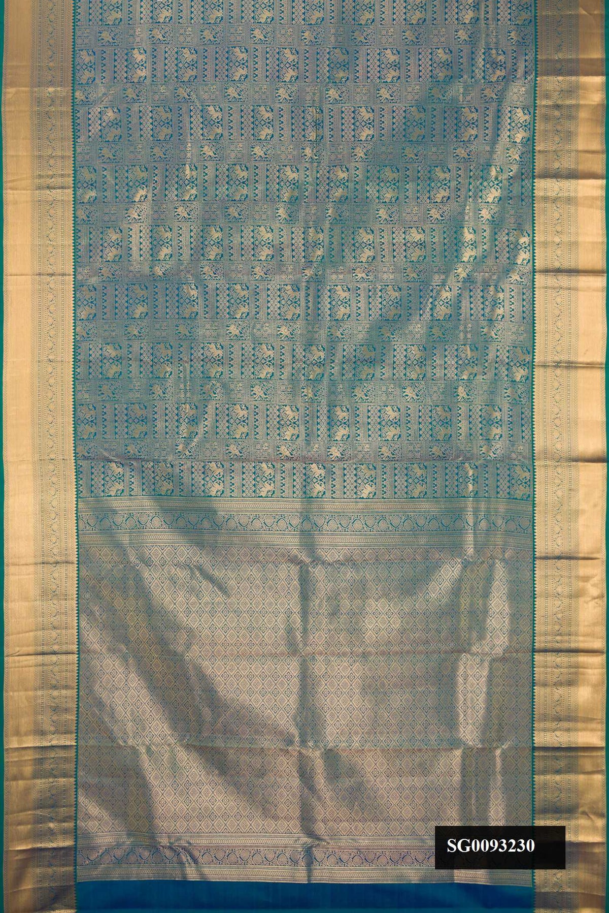 Peacock Blue Dual Tone Kanchipuram Silk Saree with Zari Brocade on the body and Zari Border.  displayed on a mannequin