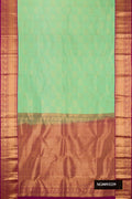 Pista Green Dual Tone Kanchipuram Silk Saree with Zari Brocade on the body and Zari Border.  displayed on a mannequin