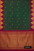 Bottle Green Dual Tone Kanchipuram Silk Saree with Zari Butta on the body and Temple Border.  displayed on a mannequin