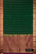 Bottle Green Dual Tone Kanchipuram Silk Saree with Zari Butta on the body and Zari Border.  displayed on a mannequin